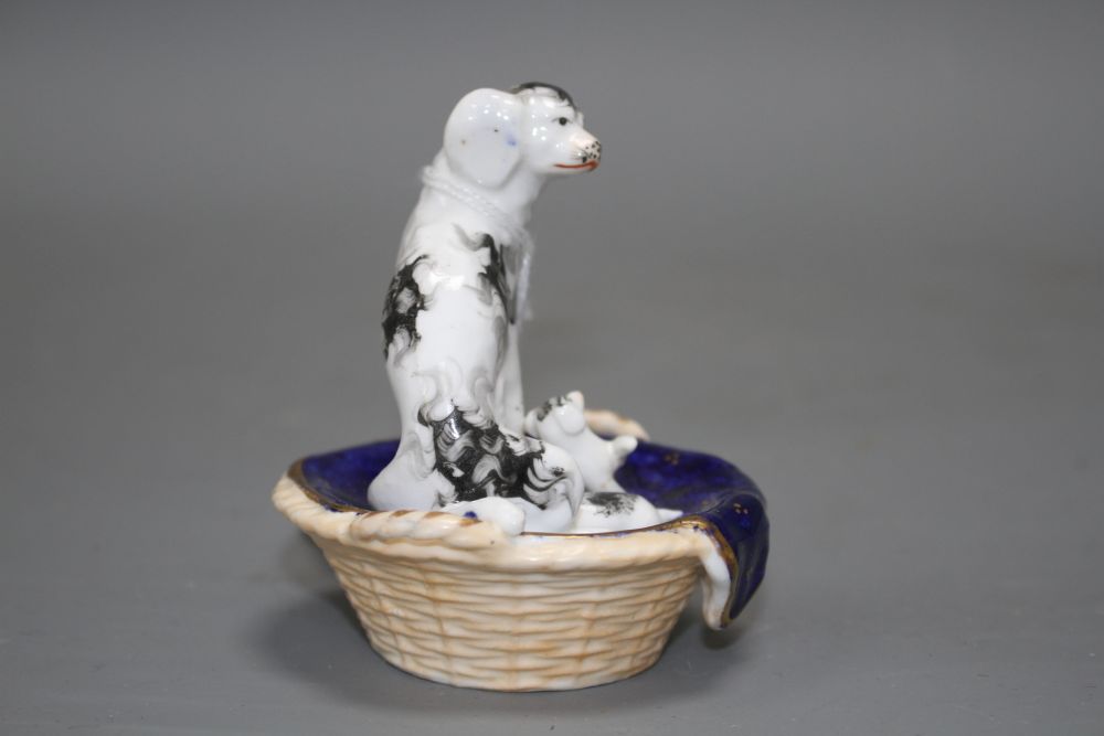 A Staffordshire group of a King Charles Spaniel and two puppies in a basket, c.1830-50, possibly Dudson,